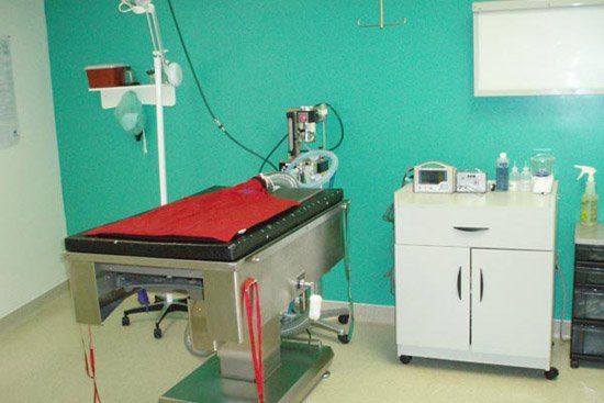 An operating room with a stainless steel operating table