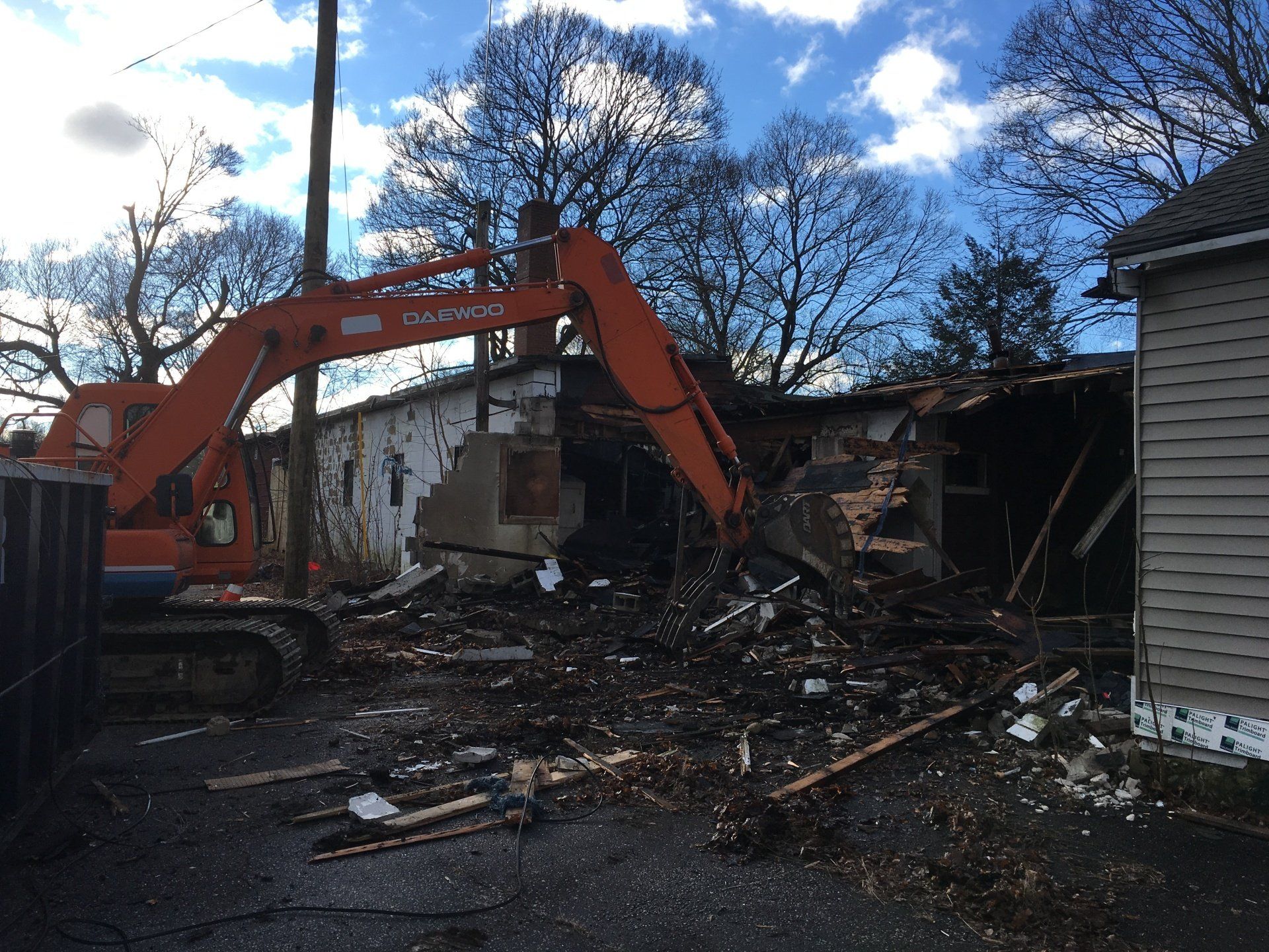 Excavator demolishing home