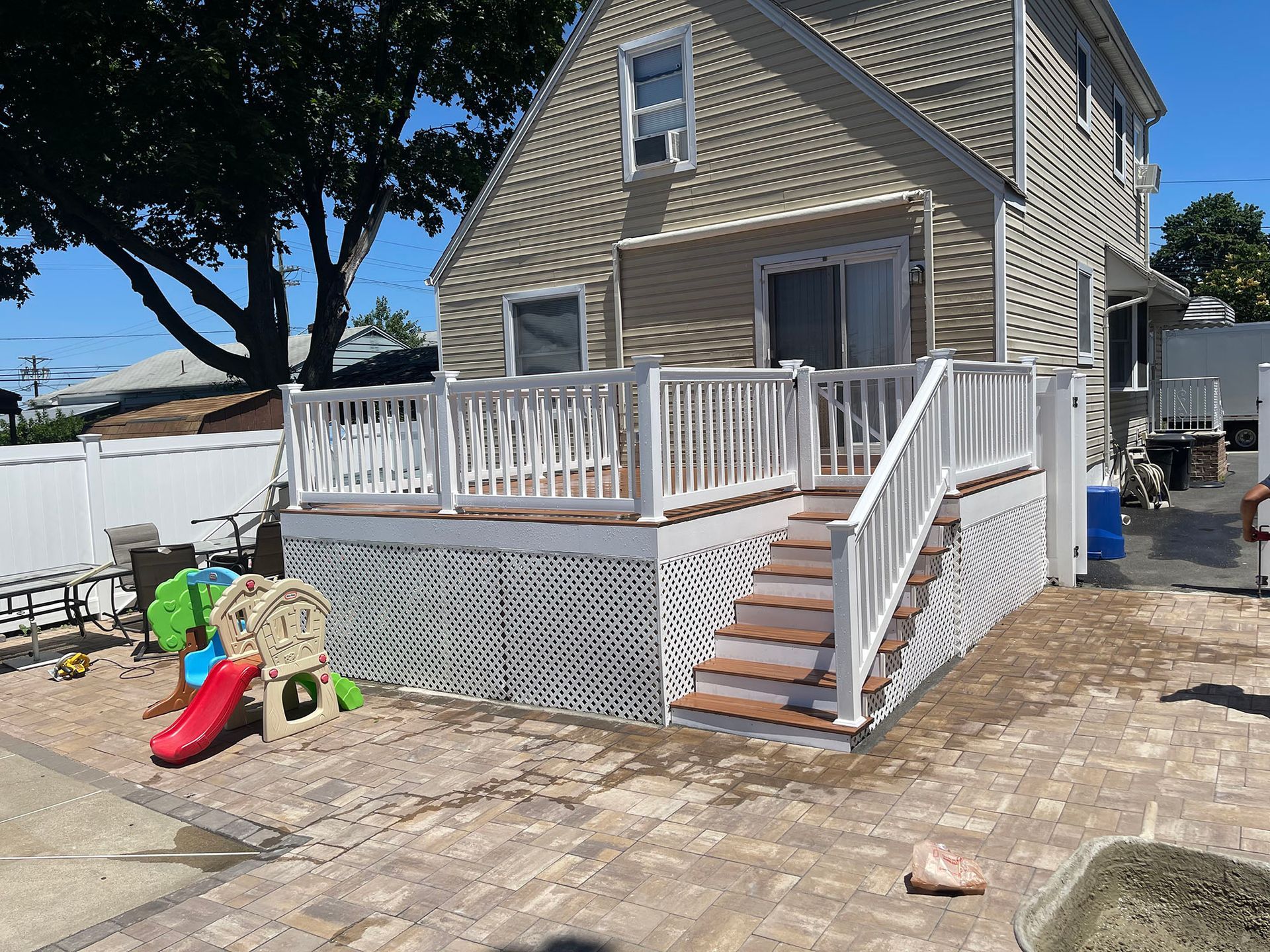 A house with a deck and stairs in front of it