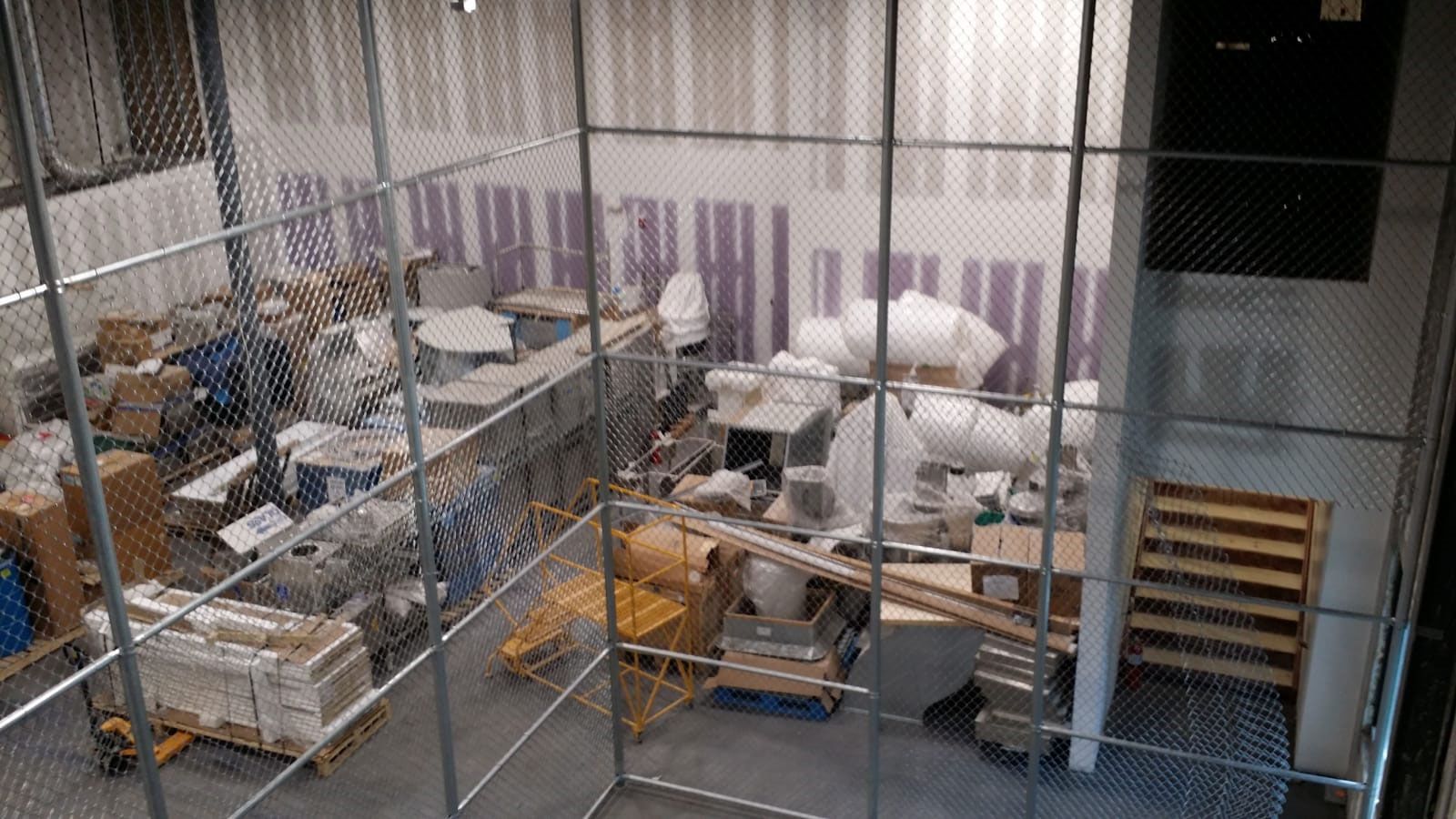 An aerial view of a warehouse filled with lots of boxes and pallets.