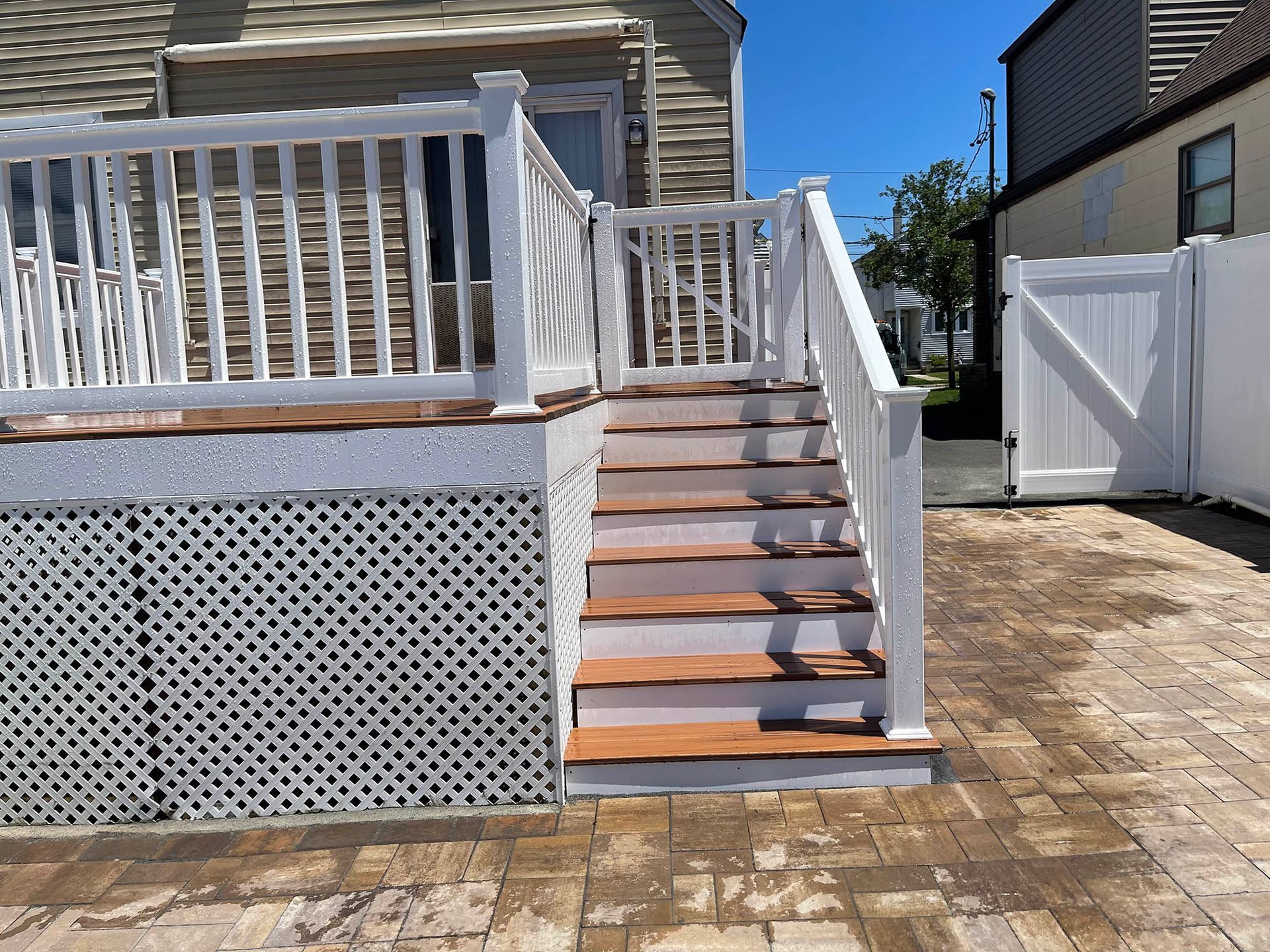 A white deck with stairs leading up to it