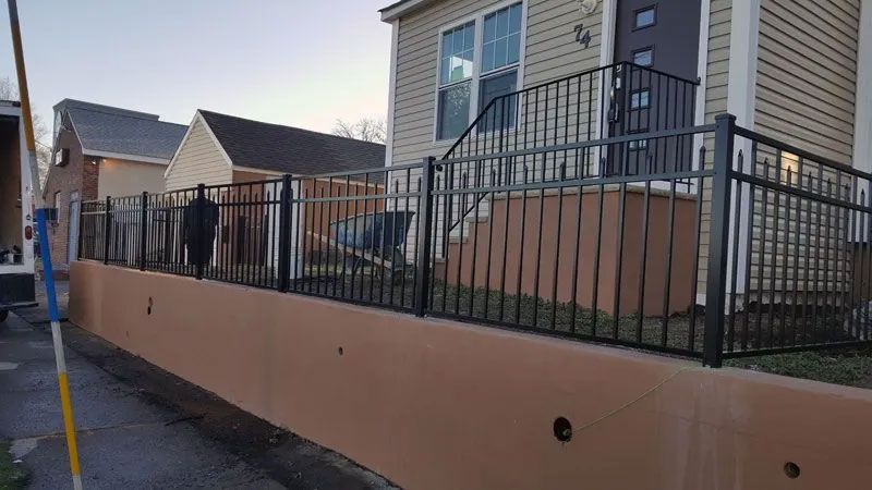 A house with a wrought iron fence around it.