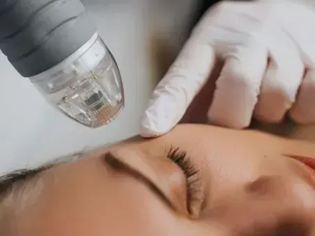 Gloved hand using a facial treatment device near a person’s closed eye