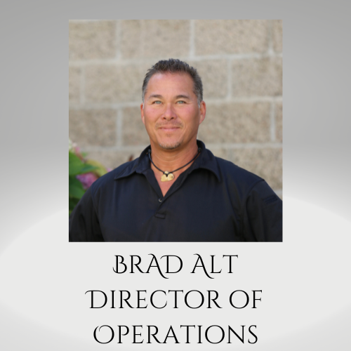 Portrait of Brad Alt, Director of Operations, in a dark shirt against a stone wall backdrop