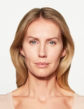 Front-facing portrait of a woman with blonde hair on a light background
