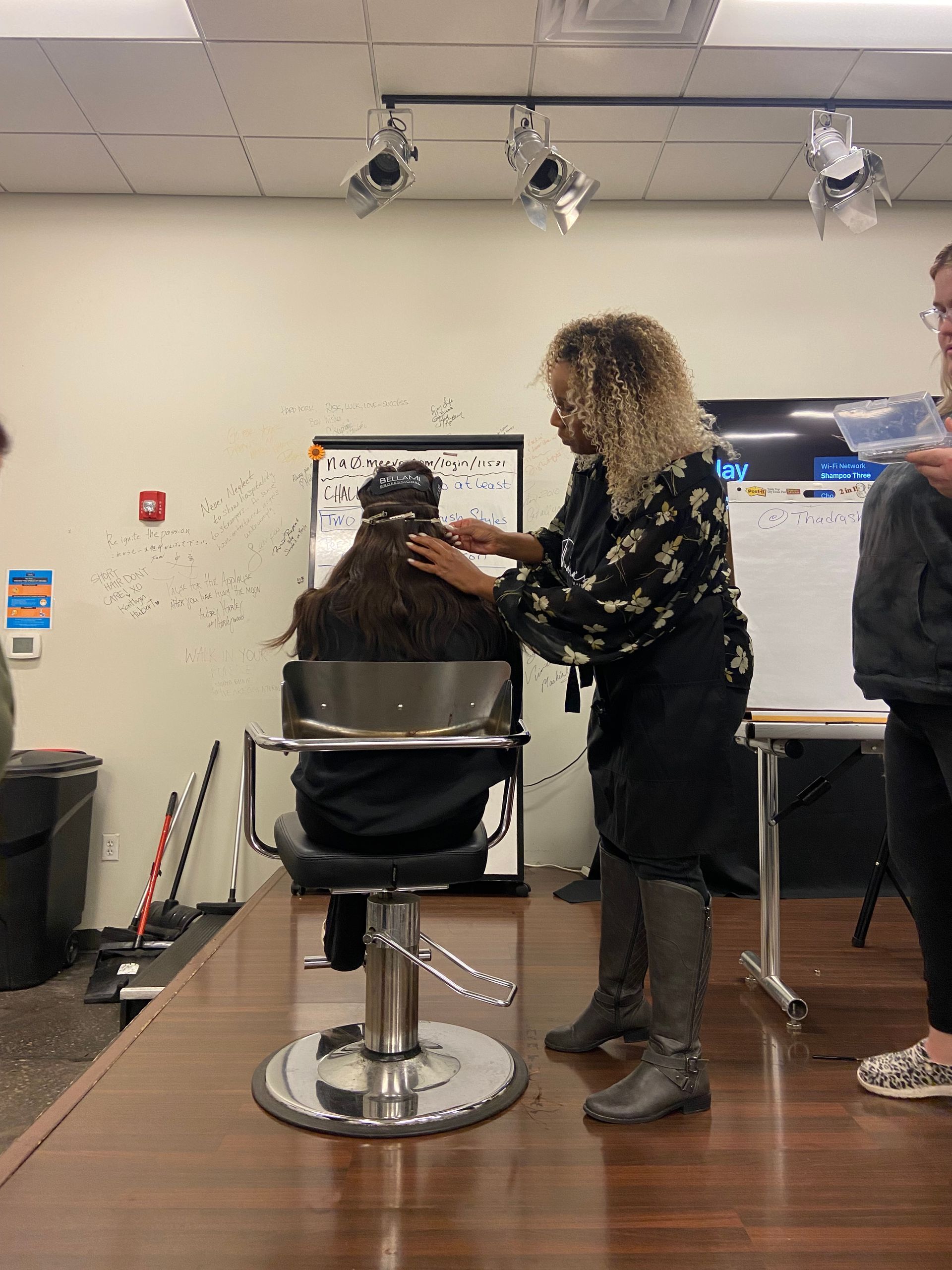 A woman is cutting a woman 's hair in a salon.