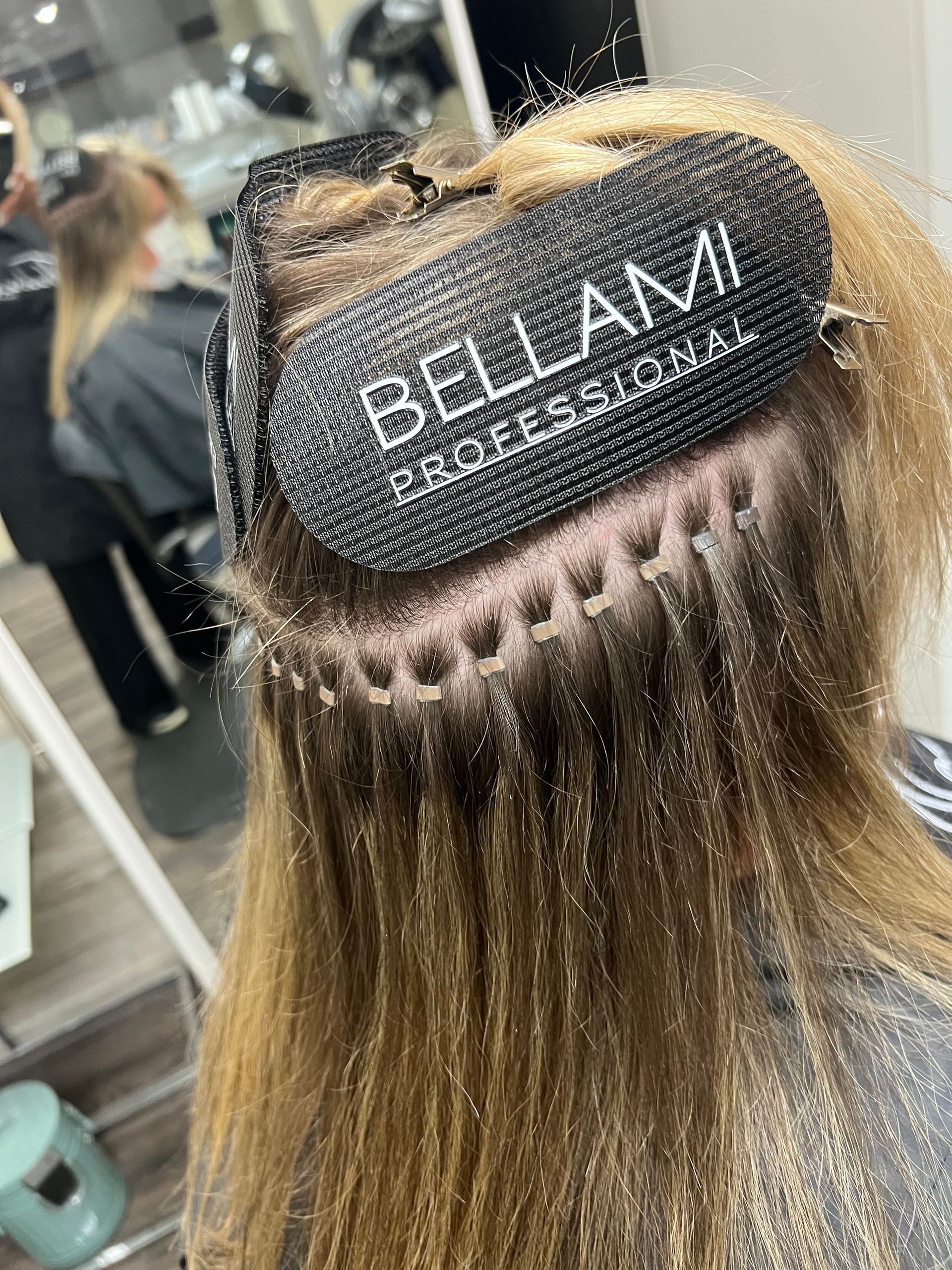A woman is getting her hair done in a salon.