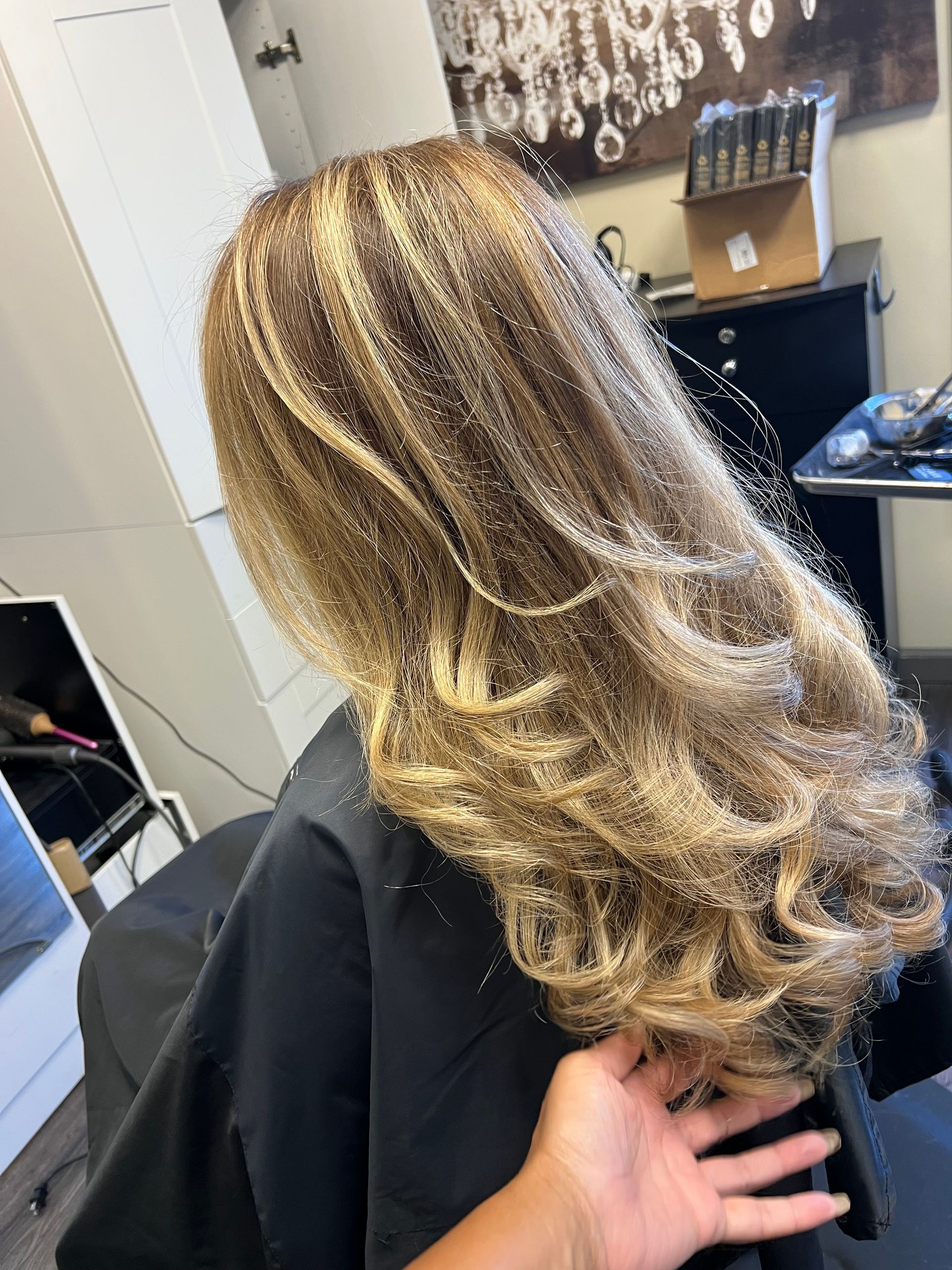 A woman is getting her hair done in a salon.