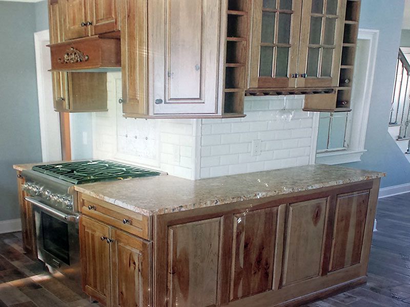 Kitchen with light wood cabinets, granite countertops, and stainless steel appliances