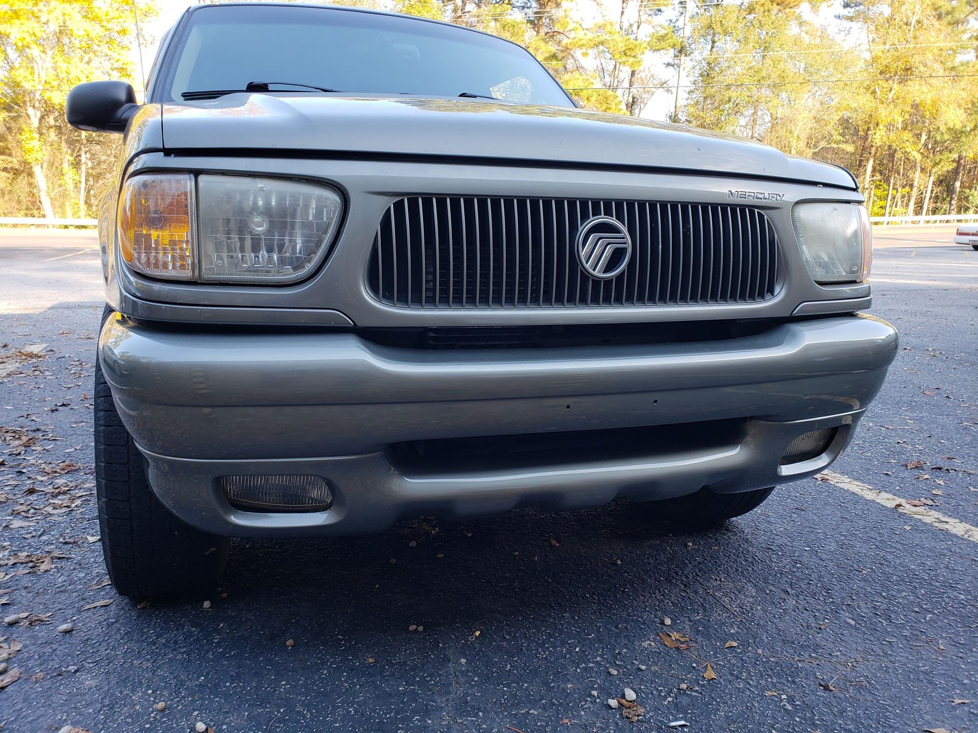 Grey Mercury Mountaineer SUV, front view, parked on asphalt.