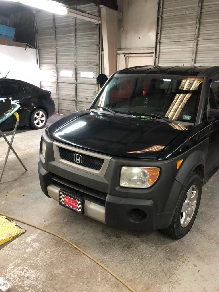 Black Honda Element SUV in a garage.