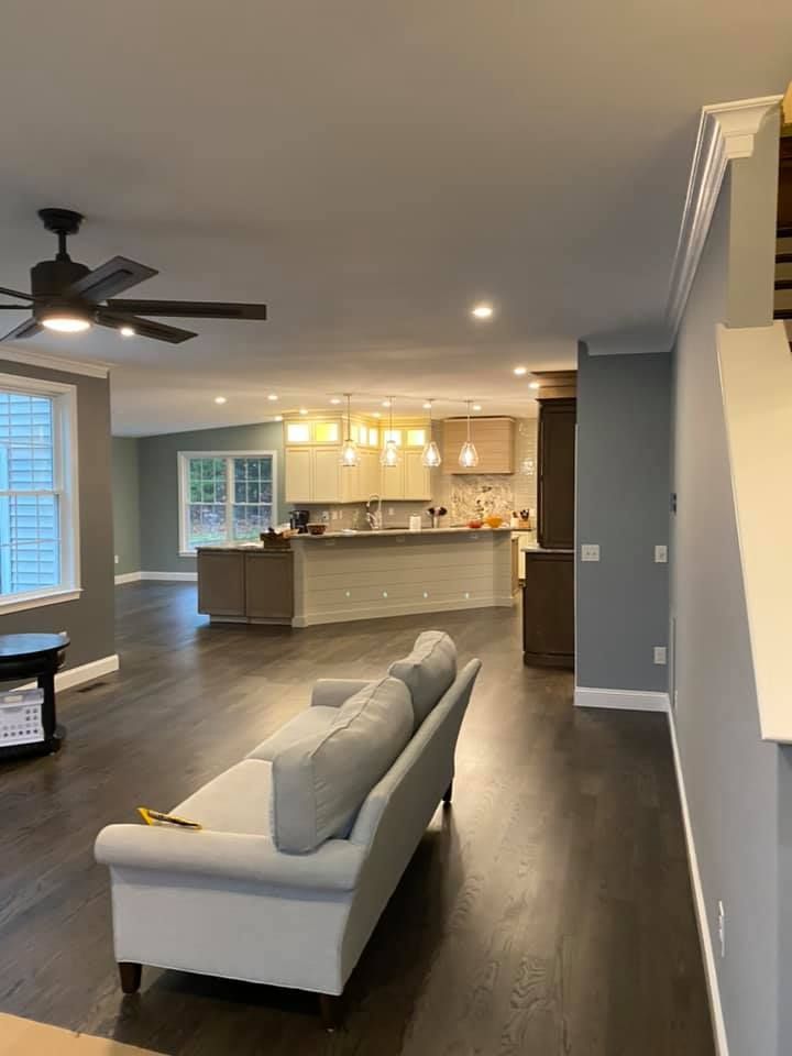 A living room with a couch and a ceiling fan.