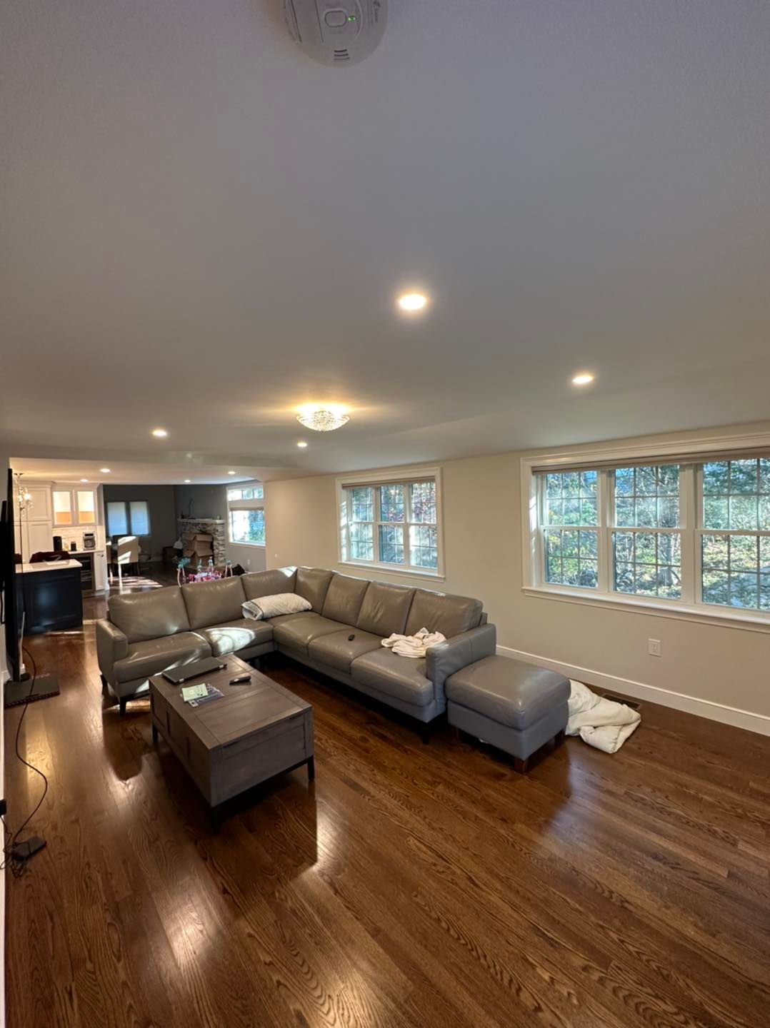 A living room with a large sectional couch and a coffee table.