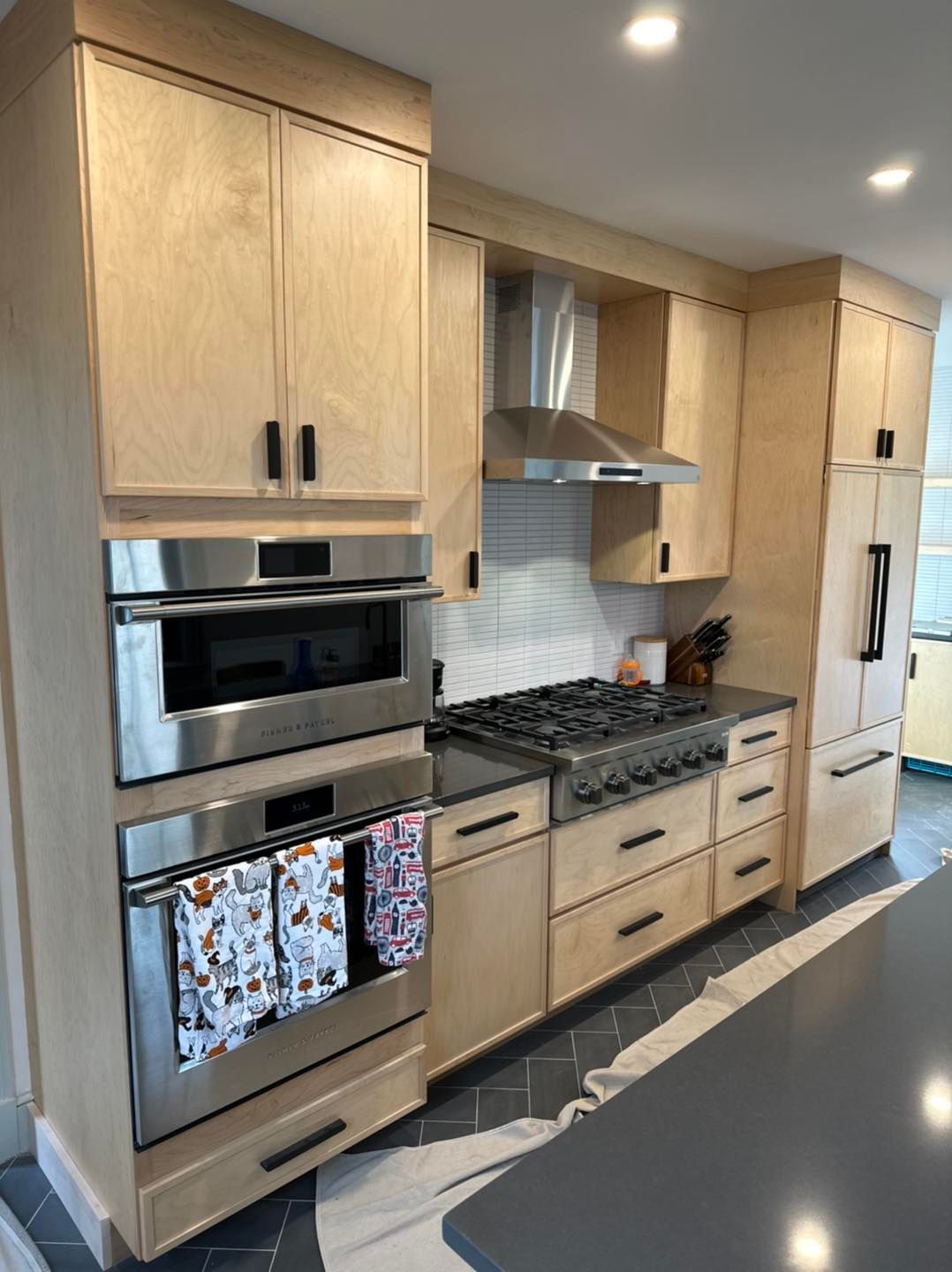 A kitchen with wooden cabinets and stainless steel appliances.