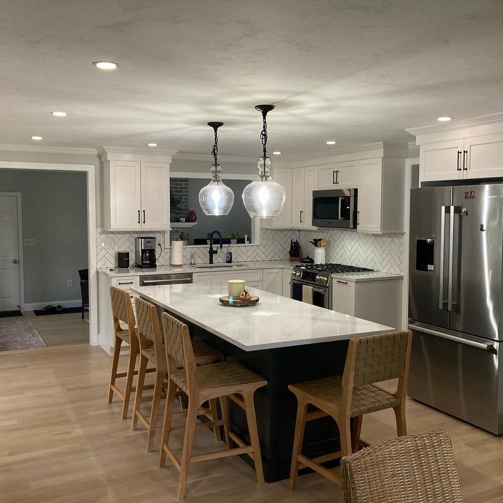 A kitchen with white cabinets and stainless steel appliances.