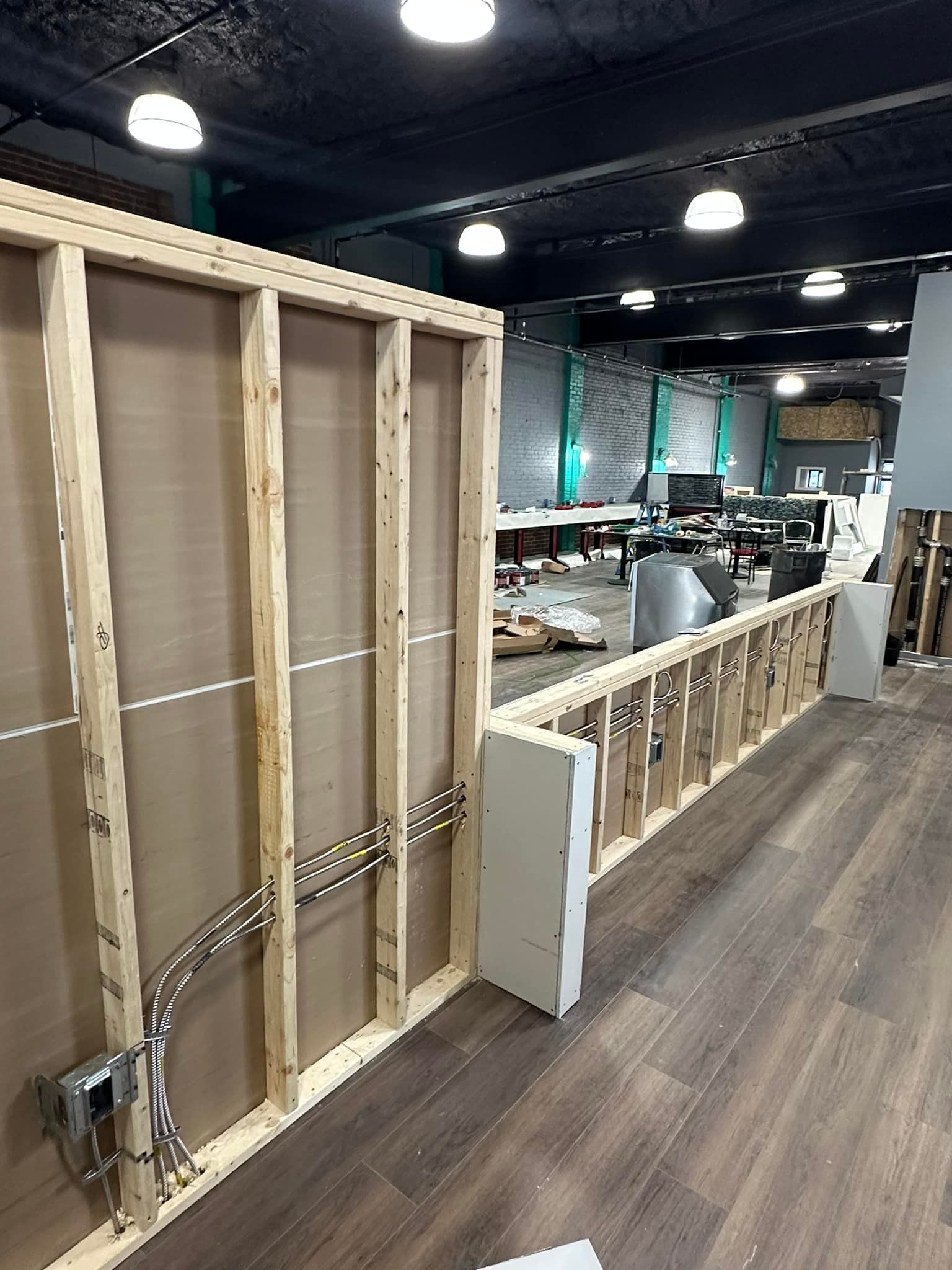 A room with a wooden wall and a wooden floor is being built.