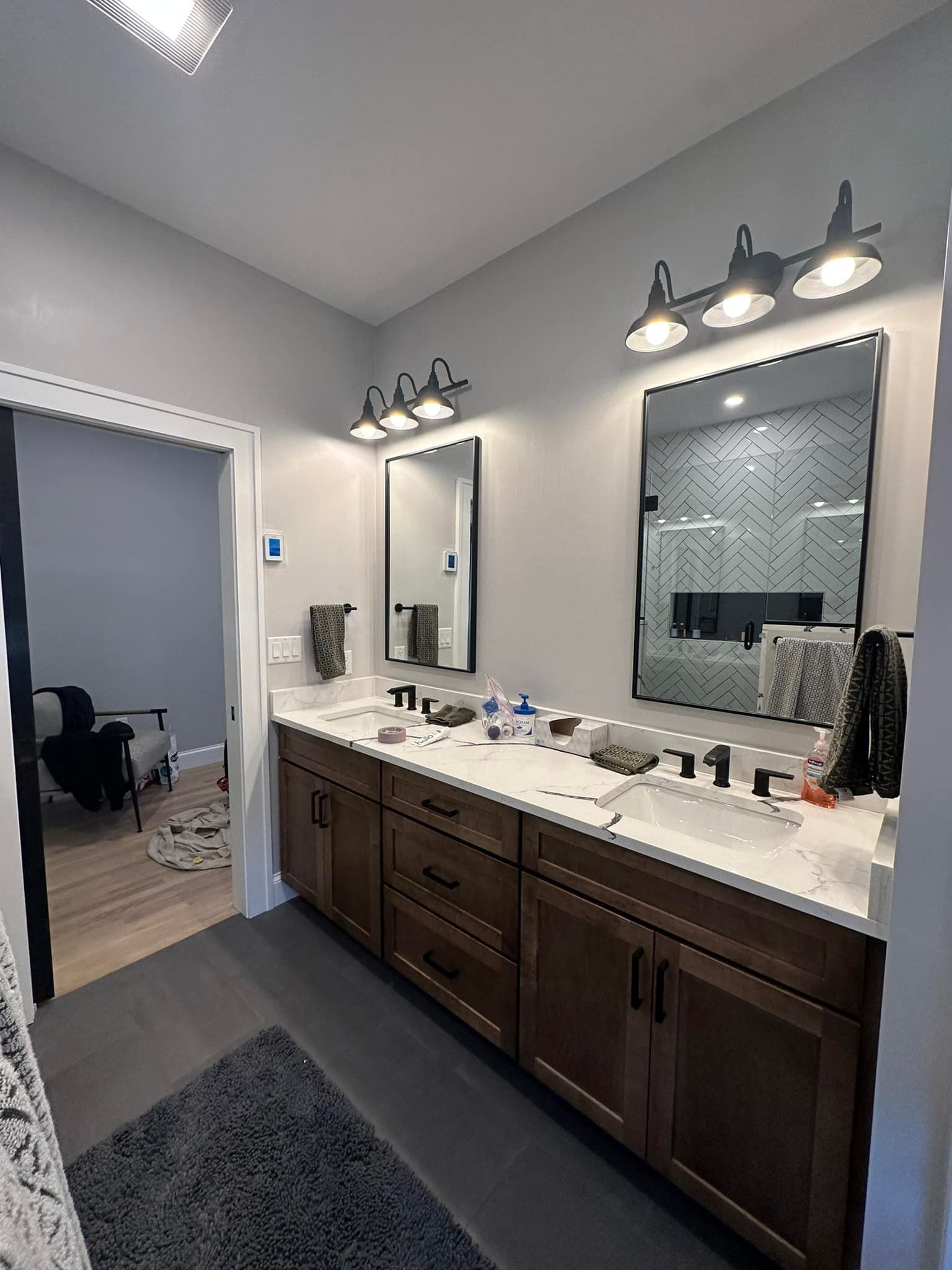 A bathroom with two sinks and two mirrors.