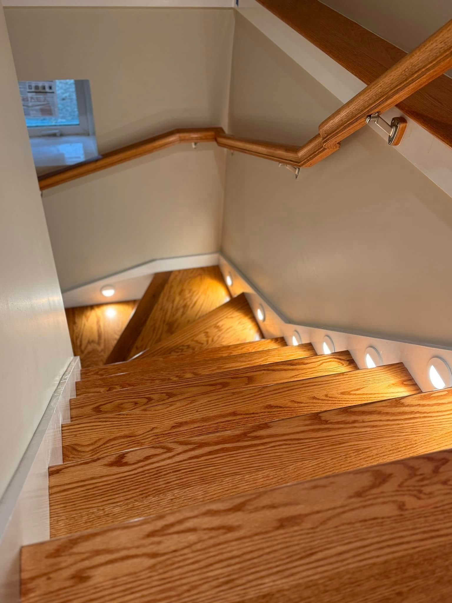 A wooden staircase leading up to the second floor of a house.