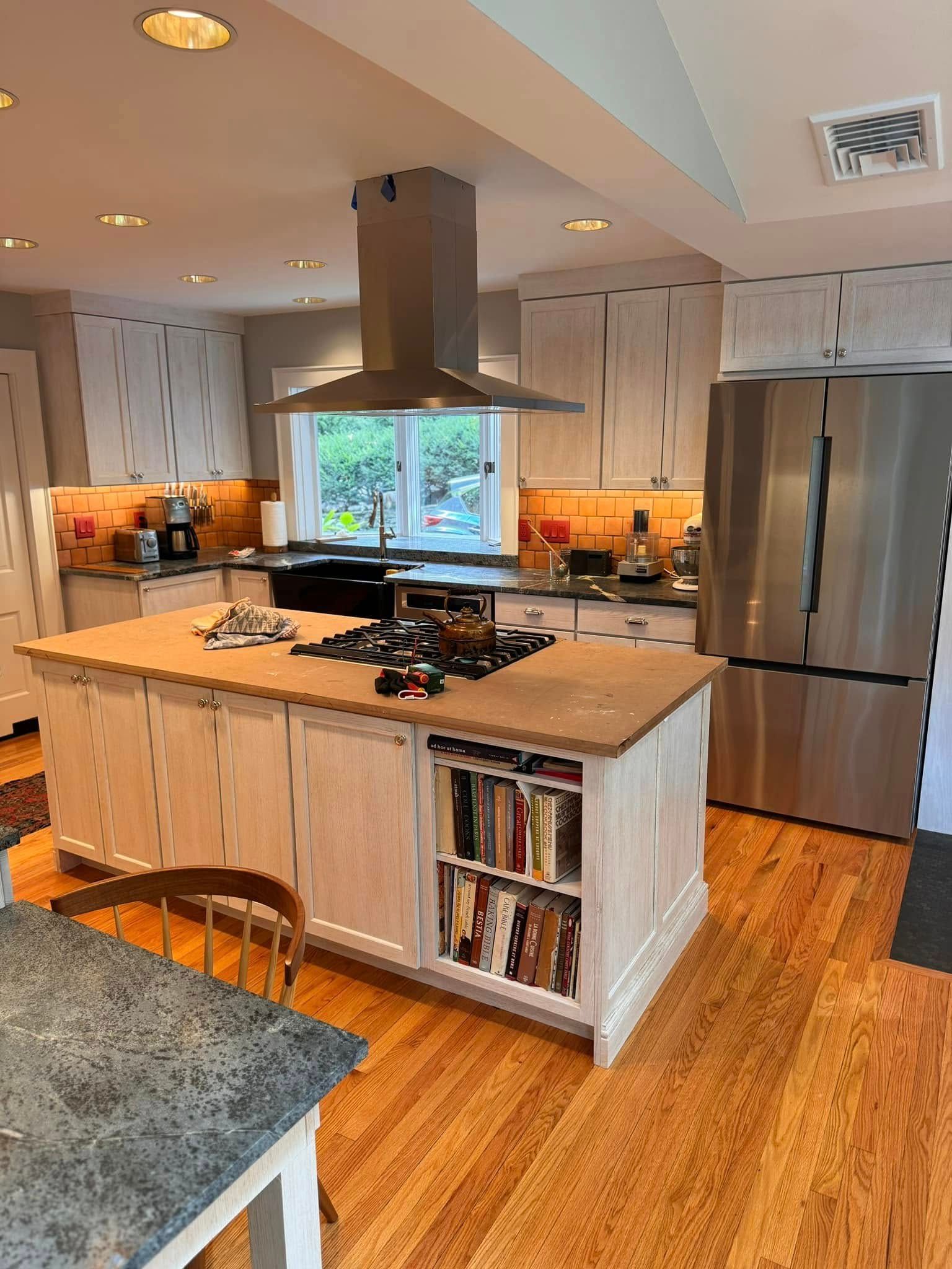 A kitchen with stainless steel appliances and a large island.