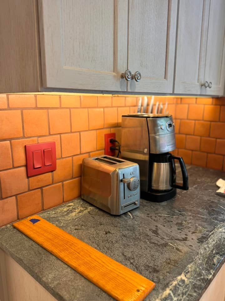 A kitchen counter with a toaster and coffee maker