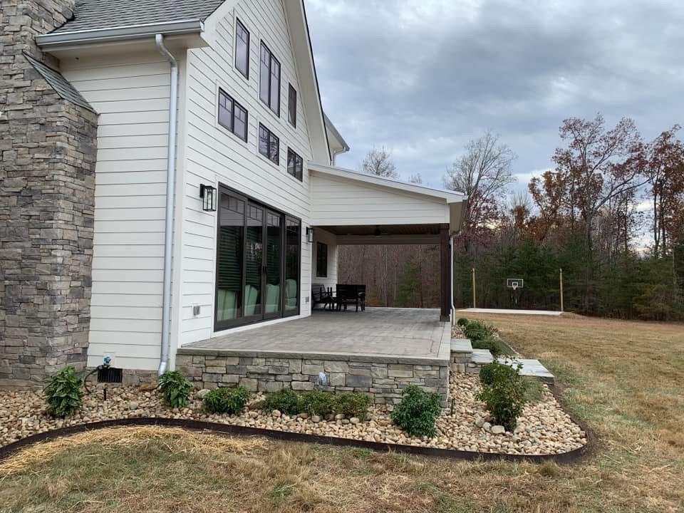 A large white house with a large patio in front of it.