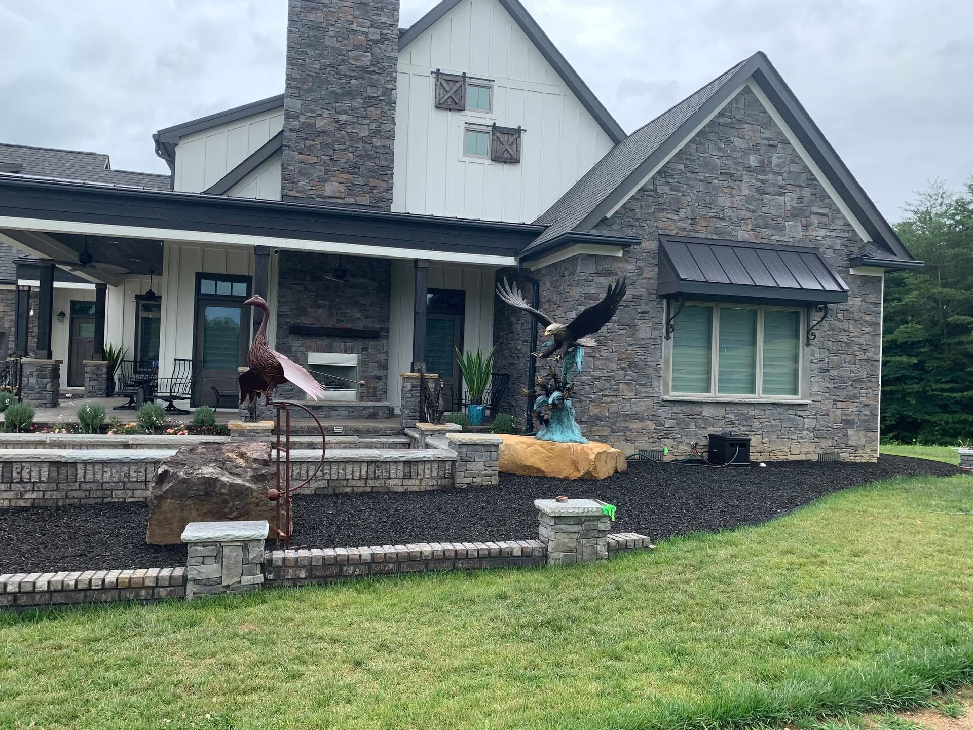 A large house with a lot of statues in front of it.