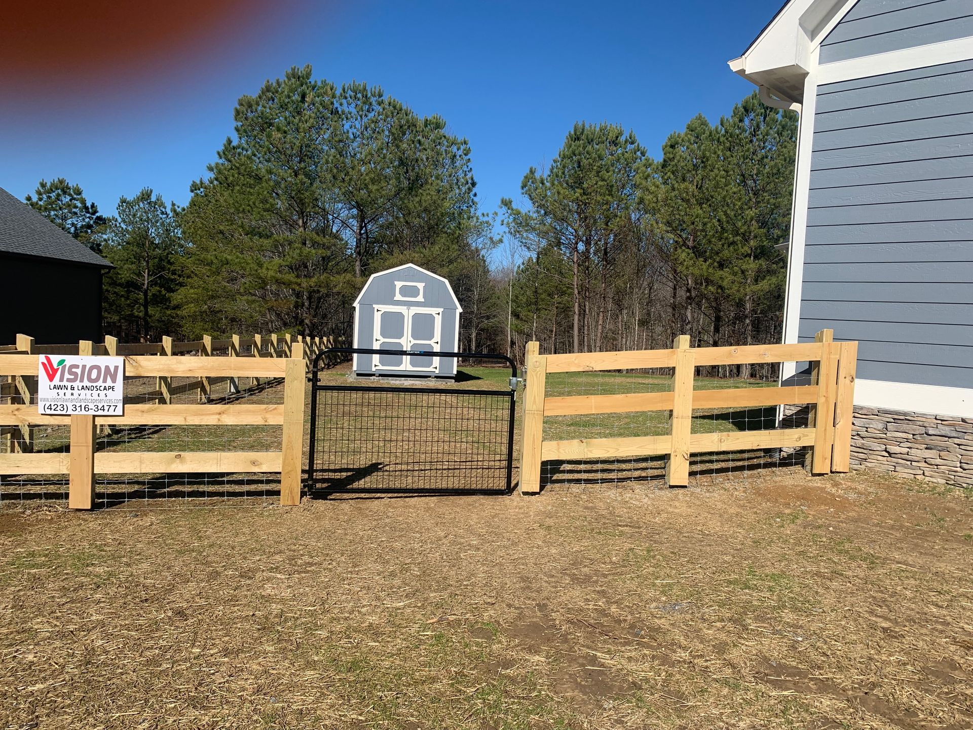 A wooden fence with a sign that says vision on it.