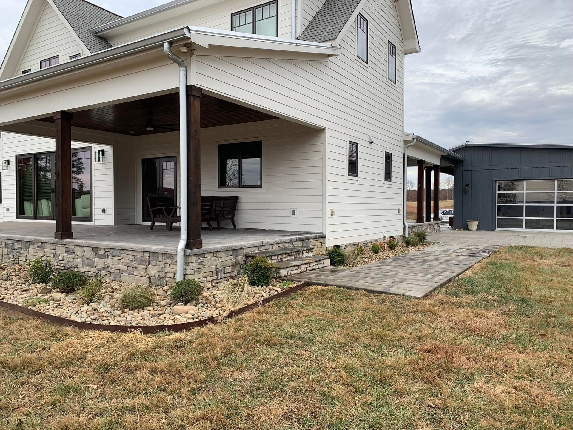 A large white house with a large porch and a garage.