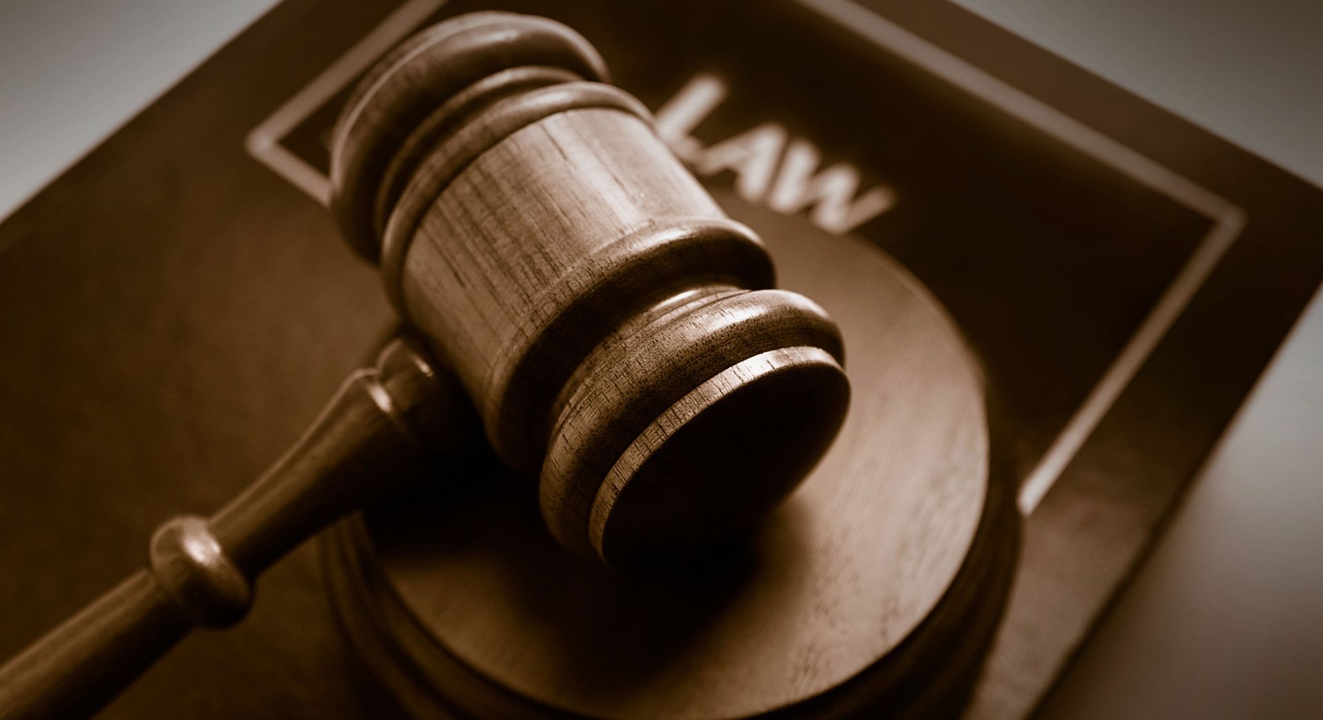 A judge's gavel on top of a law book