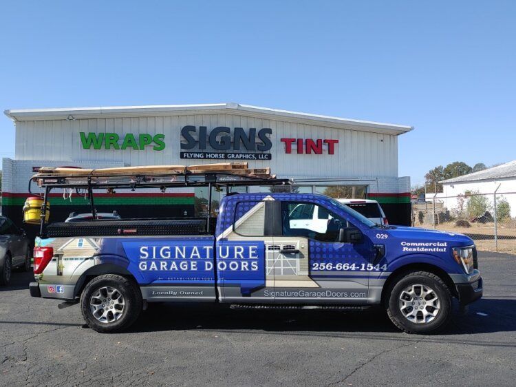 a truck is parked in front of a building that says wraps signs tint