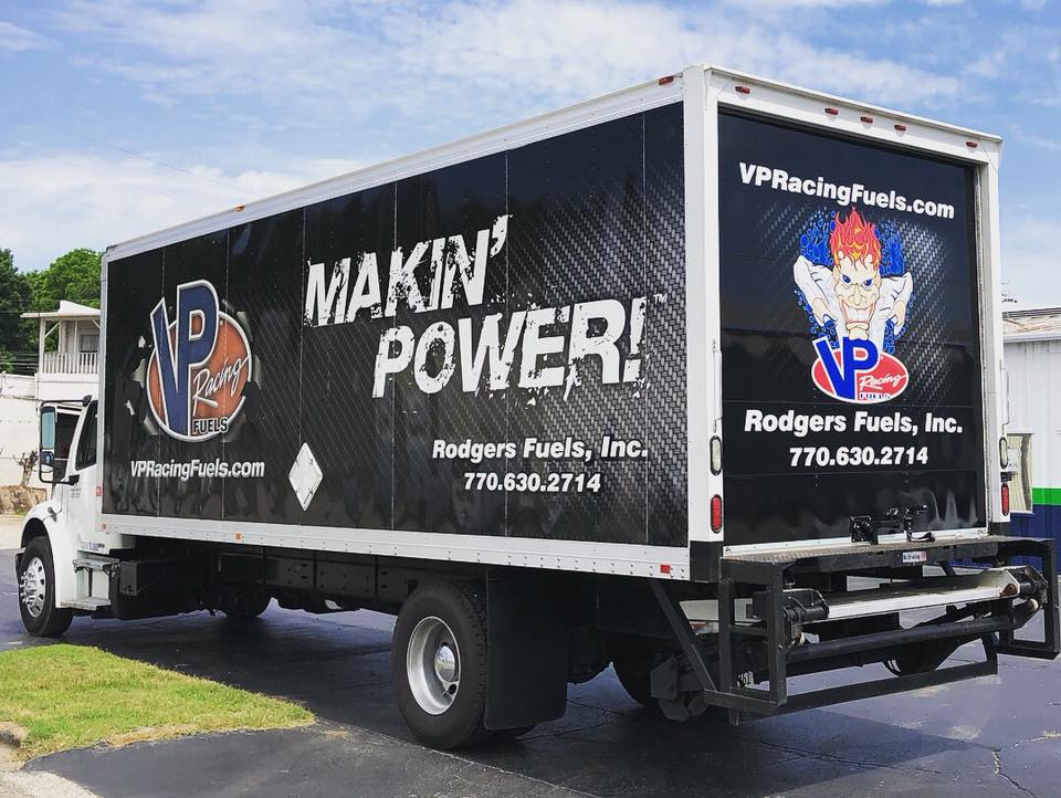 A truck that says makin' power is parked in a parking lot.