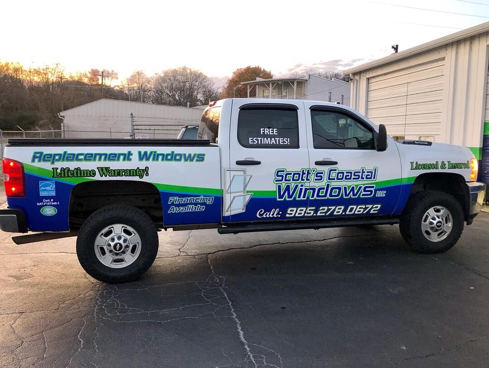 A truck with a sticker on it that says replacement windows