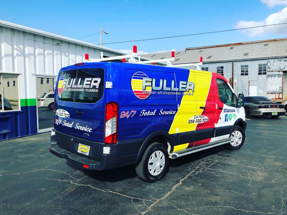 A fuller van is parked in front of a building.