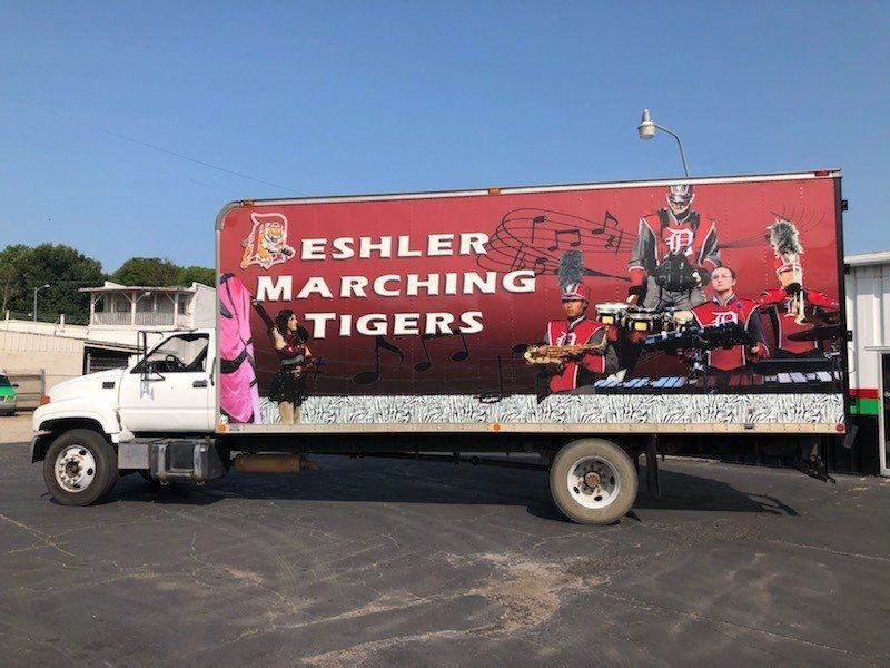 A truck with the words eshler marching tigers on the side