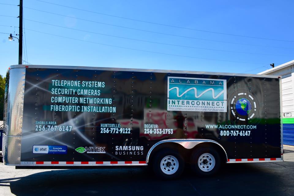 A trailer is parked on the side of the road.
