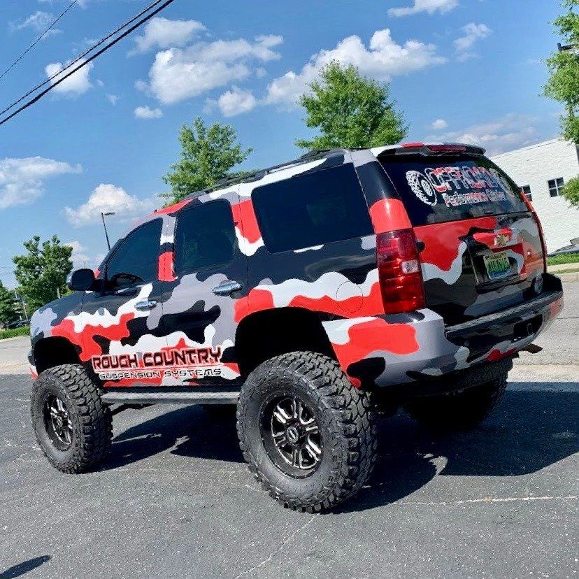 A rough country truck is parked in a parking lot