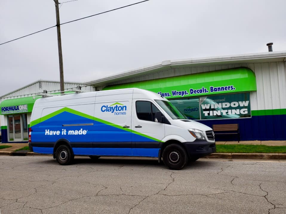 A clayton van is parked in front of a building