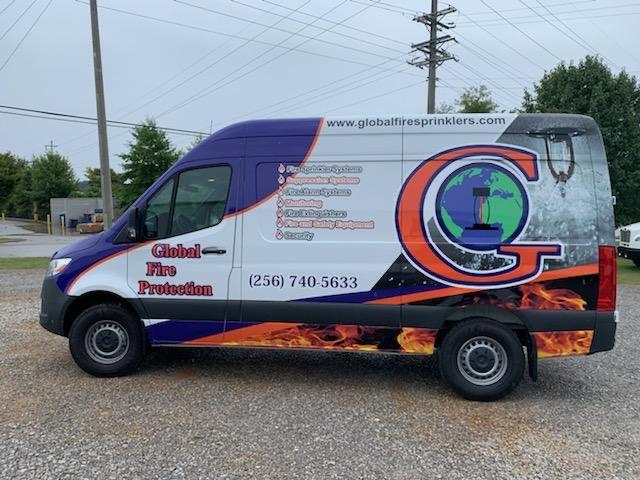 A purple and white van that says global fire protection