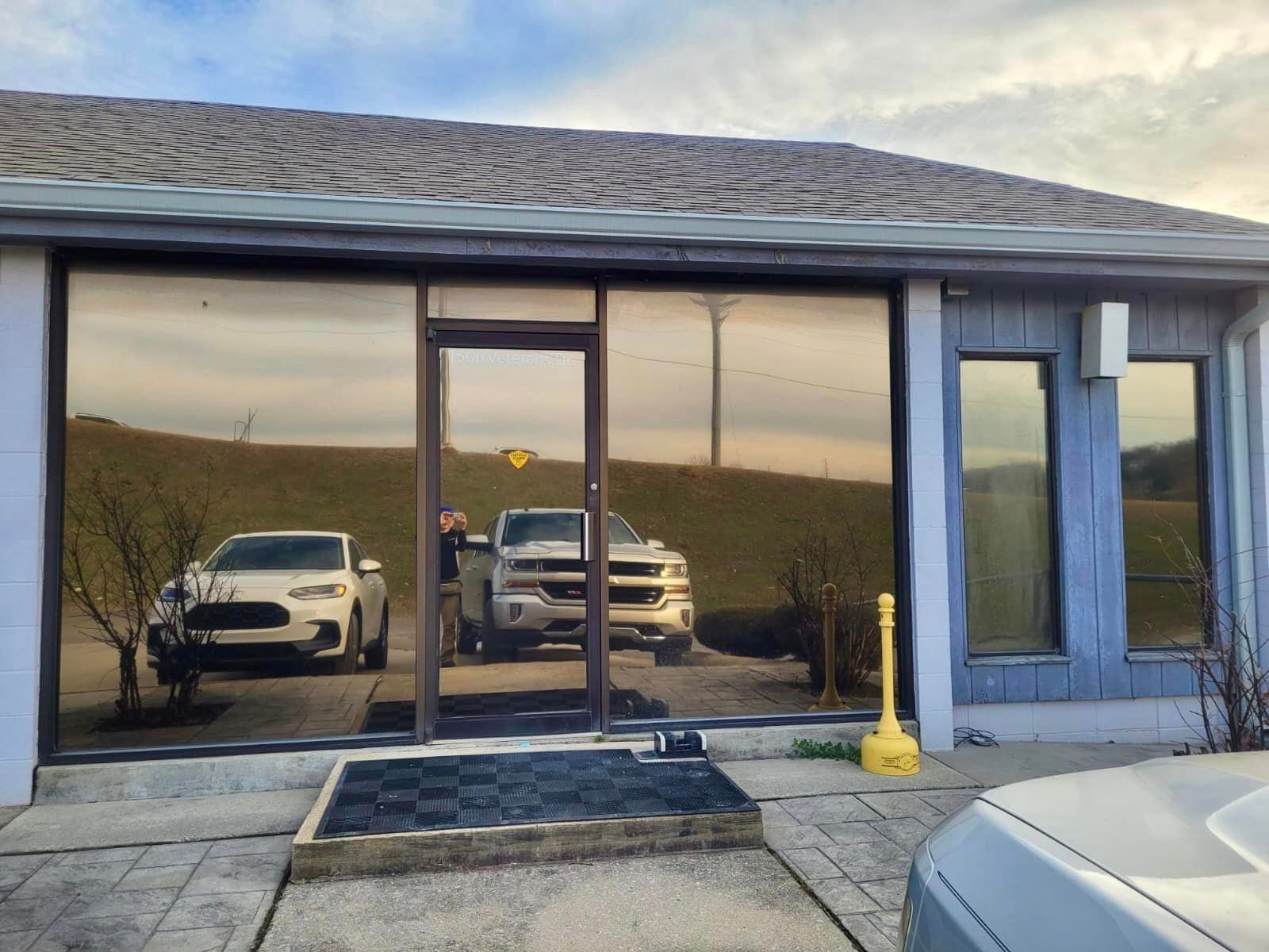 a couple of cars are parked in front of a building