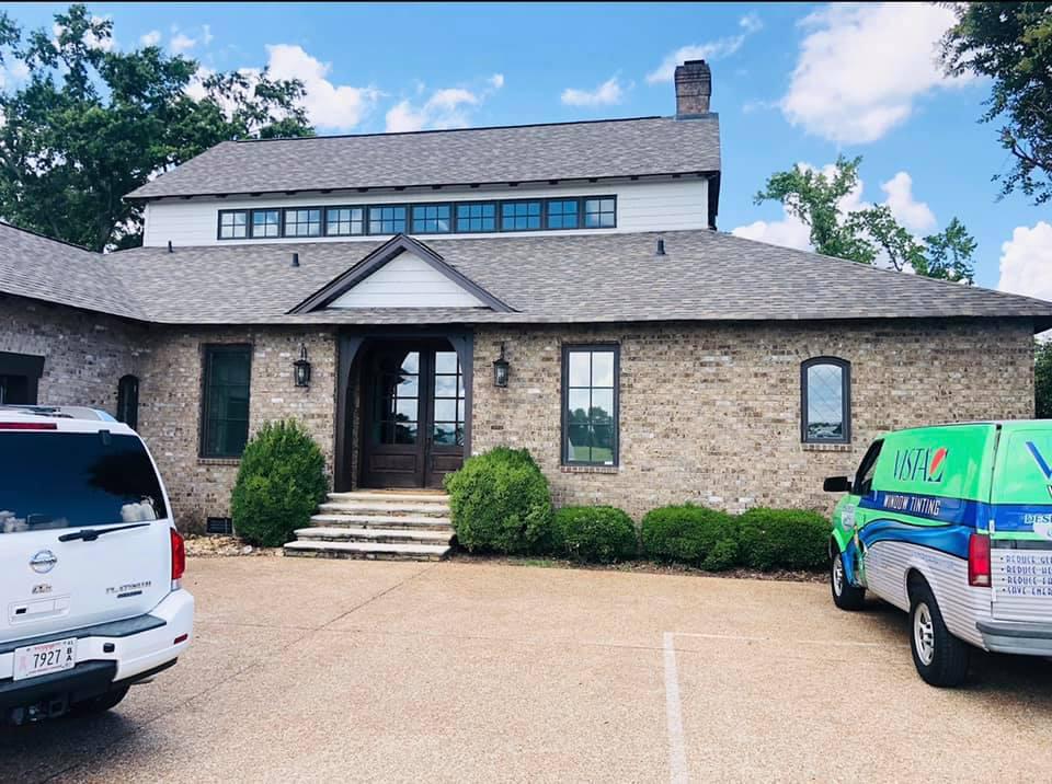 A large brick building with a van parked in front of it
