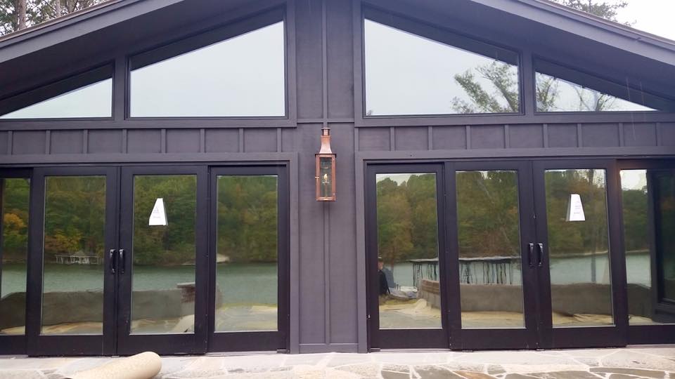 A large house with a lot of windows and sliding glass doors