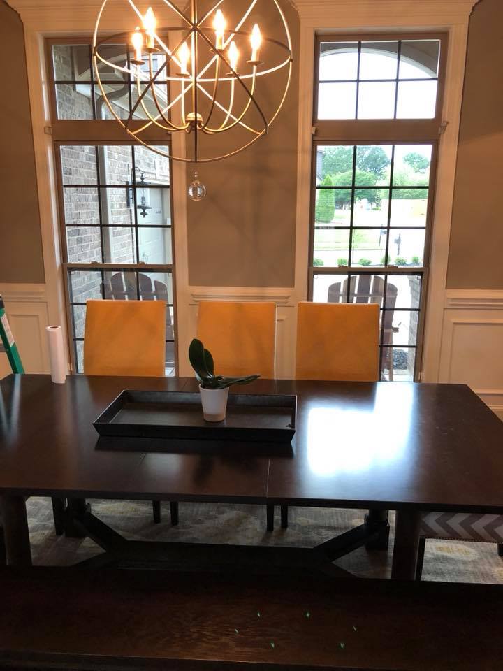 A dining room table with a potted plant on it