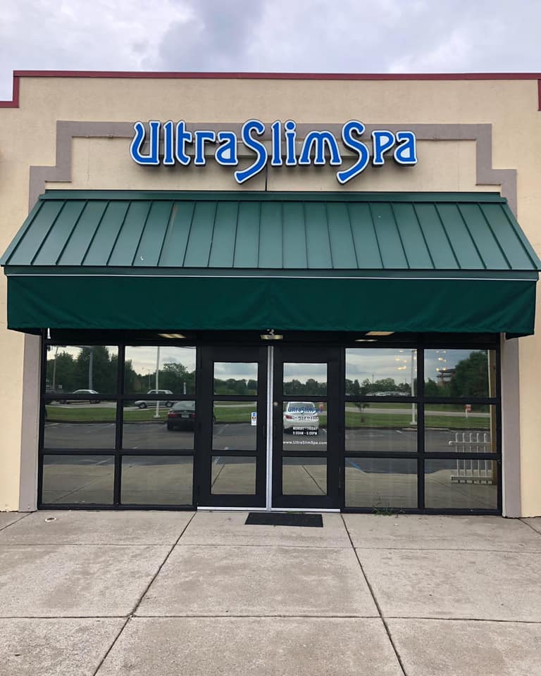 Ultra slim spa has a green awning over its doors