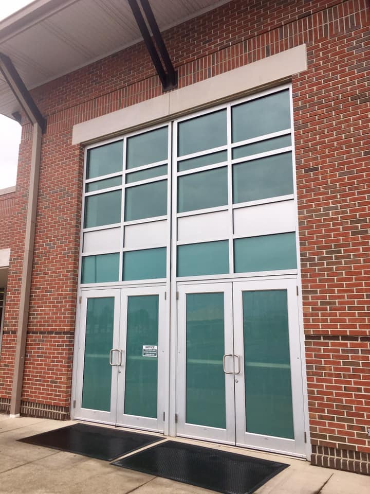 A brick building with a lot of windows and doors
