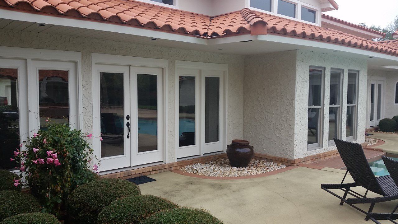 A large white house with a red tile roof