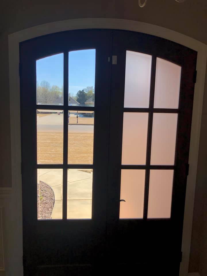 A door with a view of a field through it.