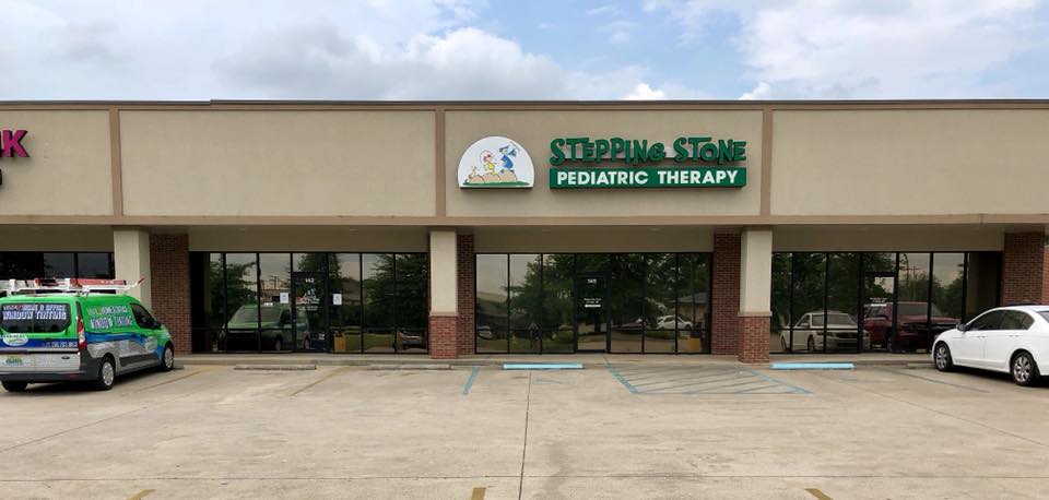 An ambulance is parked in front of a building.