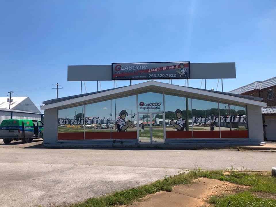 A large building with a lot of windows and a sign on top of it.