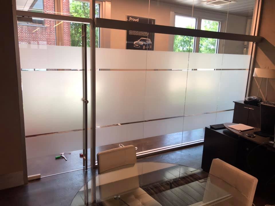 A room with a glass table and chairs in it