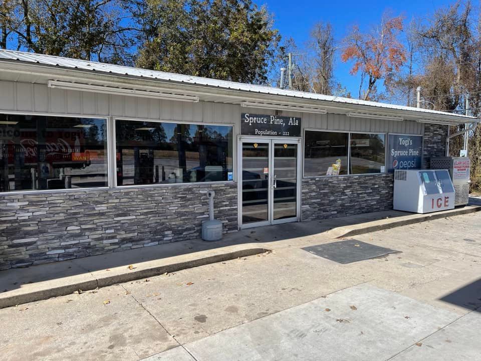 A large building with a lot of windows and a brick wall.